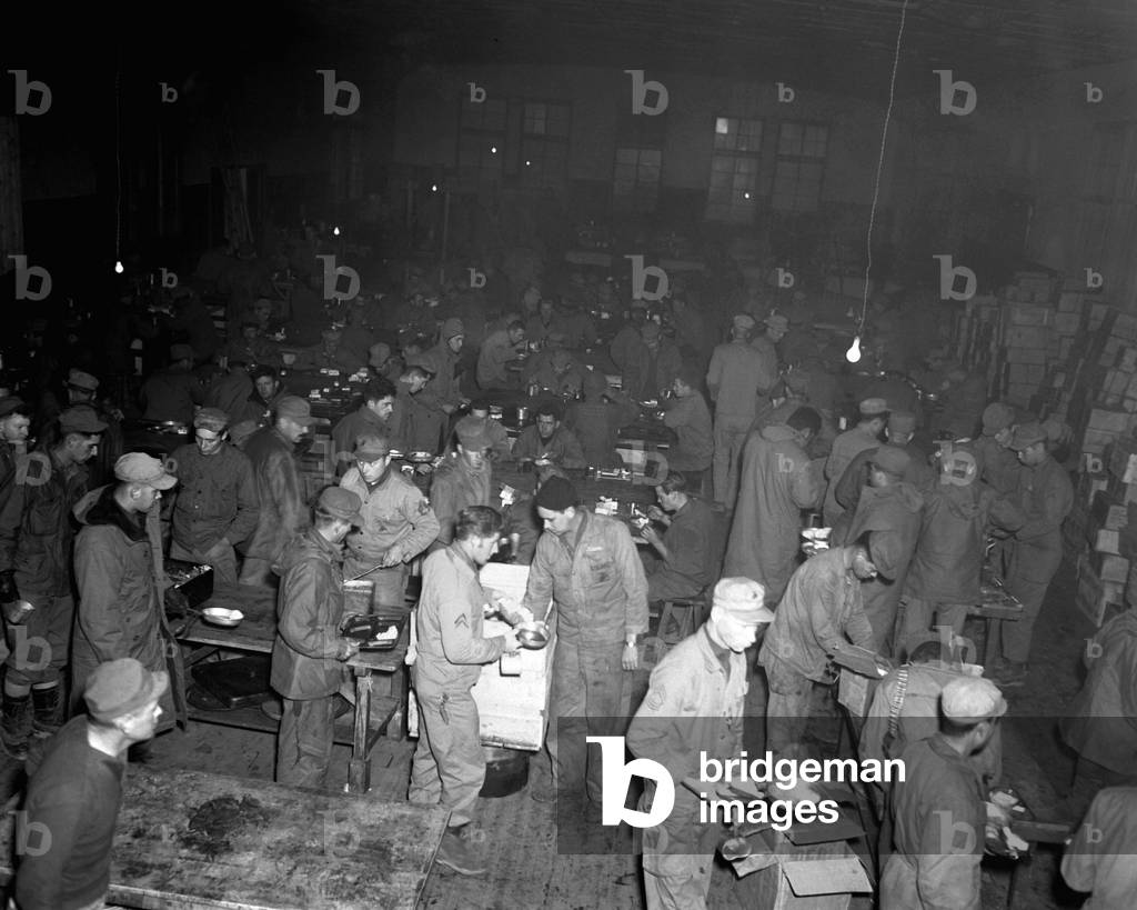 5th U.S. Marine Regiment has Thanksgiving dinner of turkey, pumpkin pie and trimmings, Nov. 23, 1950. Outside was the bleak, icy wilderness of Hagaru-ri, North Korea, with Chinese Communist 'People's Volunteer Army' bearing down on them. Korean War, 1950-53