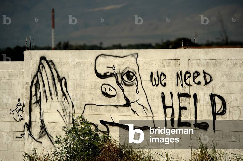Graffiti asking for help is painted on a wall on January 22 2010 in Port au Prince Haiti. 7.0-magnitude earthquake on January 12 2010