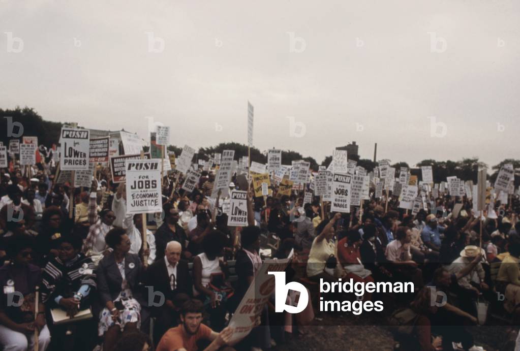 Integrated group of including senior citizens protesting against 1970s inflation unemployment and high taxes along Lakeshore Drive in Chicago. The protest was organized by Operation Push the African American non-profit organized by Jesse Jackson. July 1973