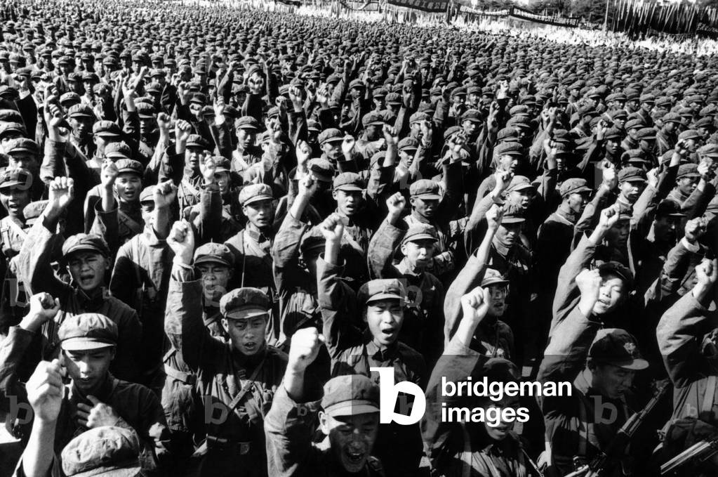 Thousands of Red Army soldiers raise their clenched fists. They pledged 'to fight abreast the Vietnamese people to thor oughly wipe out the heinous U.S. gangsters'. This occurred during as the Chinese Communist Army celebrated its 39th birthday Monday, August 1, 1966