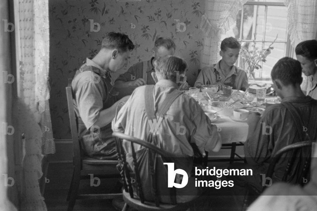 Old and young farmers having a full dinner during wheat harvest time, central Ohio. August 1938
