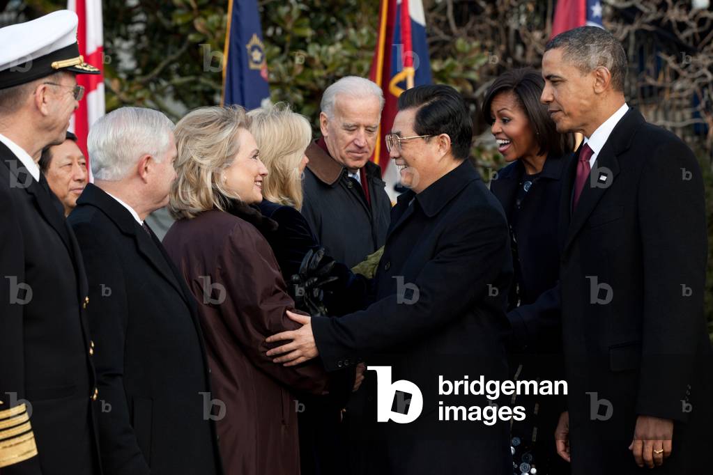 Chinese President Hu Jintao greets the Hillary Clinton as he begins his US state visit. President and Michelle Obama VP and Jill Biden Robert Gates and Mike Mullen are also in the photo. Jan. 19 2011. (BSWH_2011_8_240)
