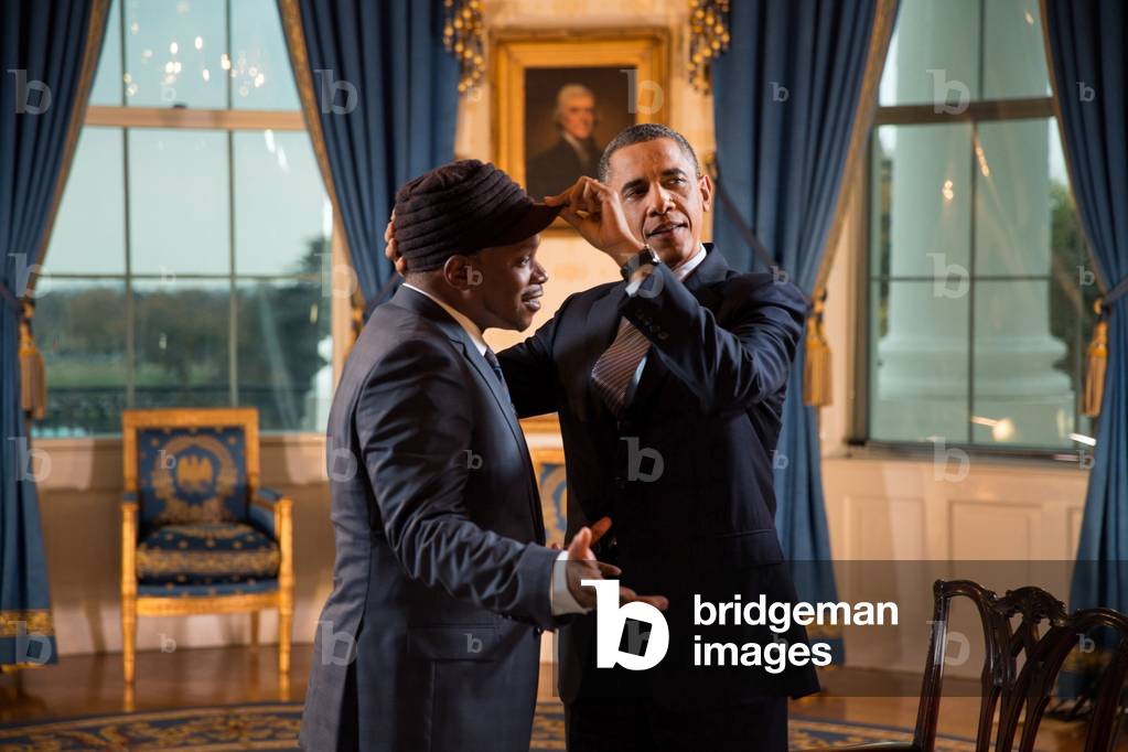 President Barack Obama adjusts Sway Calloway's hat in the Blue Room of the White House. The President gave an interview for a Live MTV special. Oct. 26, 2012