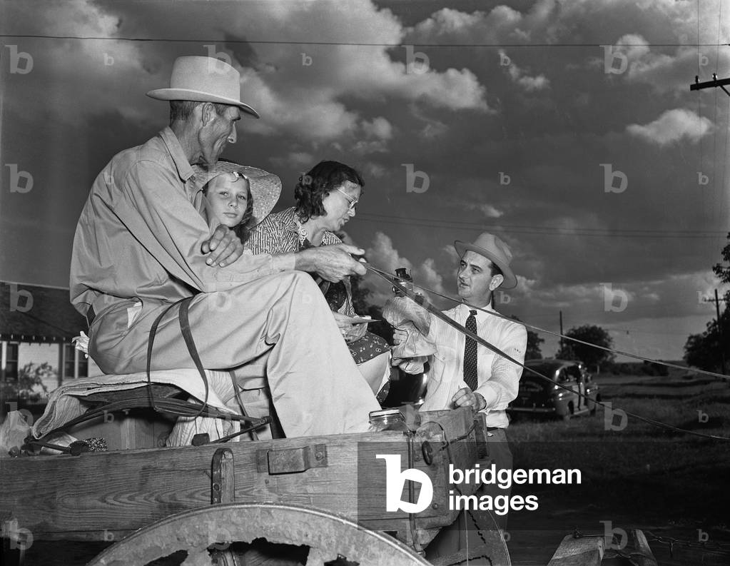 Congressman Lyndon Johnson campaigning with a family on a horse drawn wagon in Texas May 31 1941