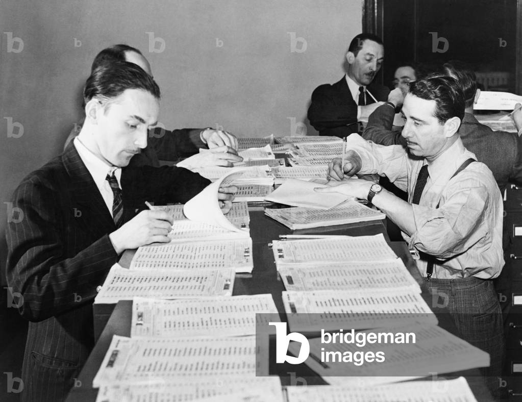 Workers checking names and numbers at New York Selective Service headquarters. On March 17, 1942 numbers were drawn in Washington in the nation's first wartime lottery since 1918. World War 2