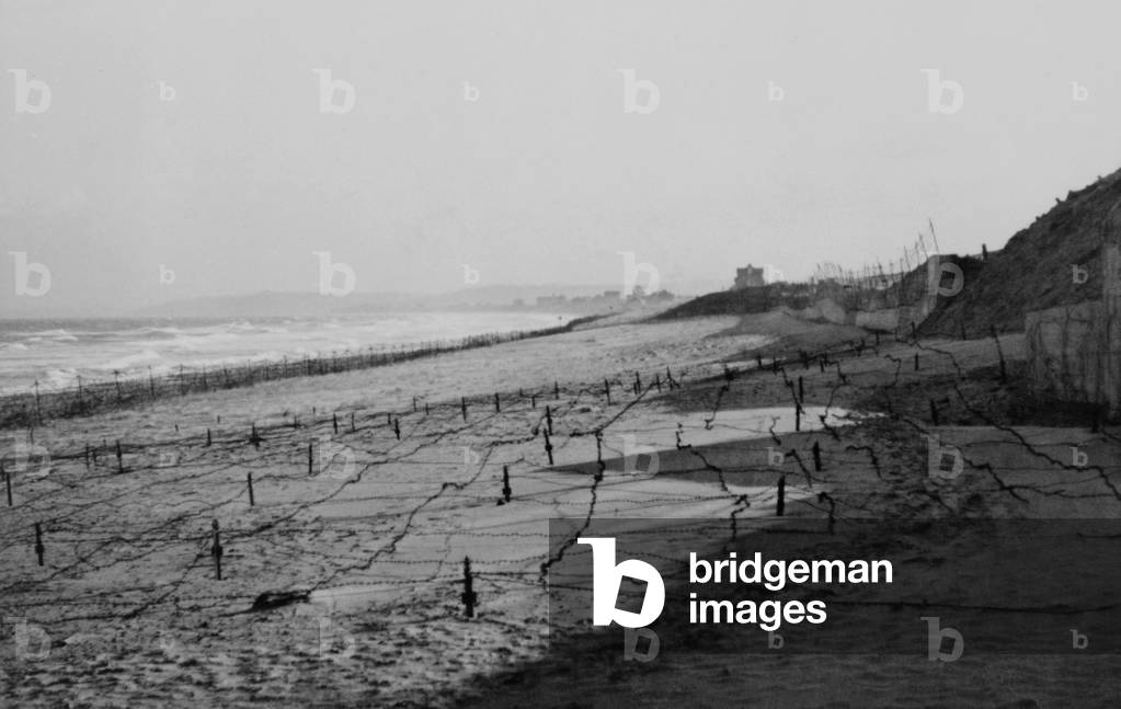 German barbed wire obstacles on the beach at Franceville, Brittany, France. 1944. World War 2