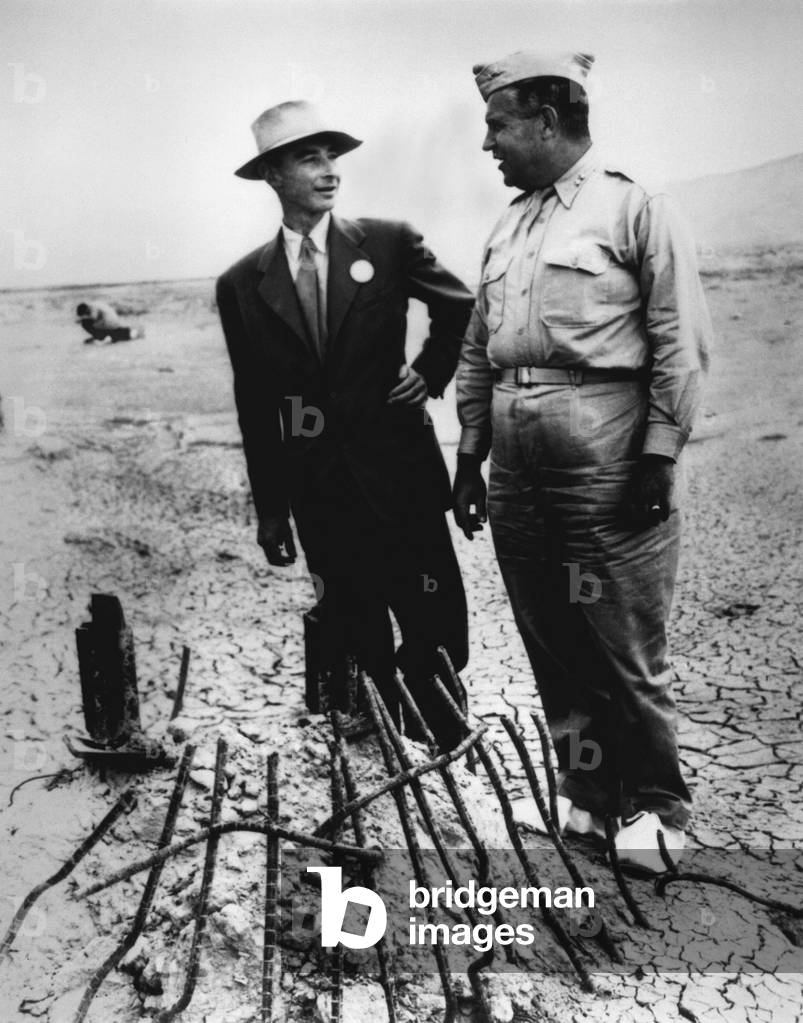 Gen. Leslie Groves (r) and Dr. J. Robert Oppenheimer at Trinity Test Site in Sept. 1945. They examine the remains of the tower from which the first manmade atomic explosion was detonated near Alamogordo, New Mexico