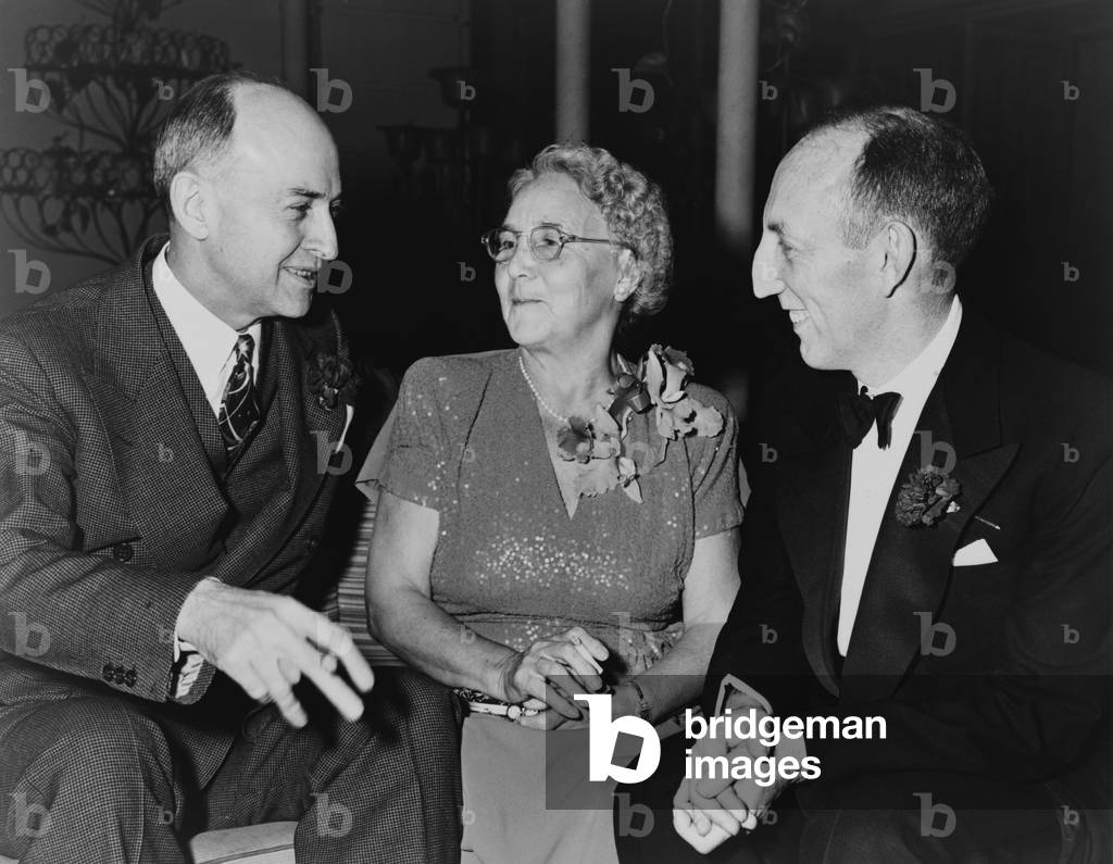 Mrs. Lena Bryant Malsin 1879-1951 founder of Lane Bryant Inc. with her son Raphael Malsin President of Lane Bryant Inc. right and Keen Johnson Undersecretary of Labor left at testimonial dinner honoring her in New York City in 1947. She beg
