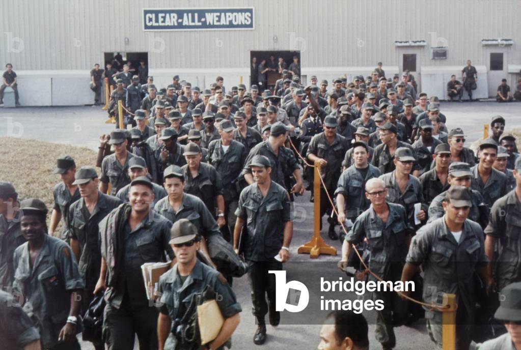 Vietnam War. Having finished their tours of duty, smiling US troops wait at the Bien Hoa Air Terminal for a National Airlines flight home. Feb. 15, 1968