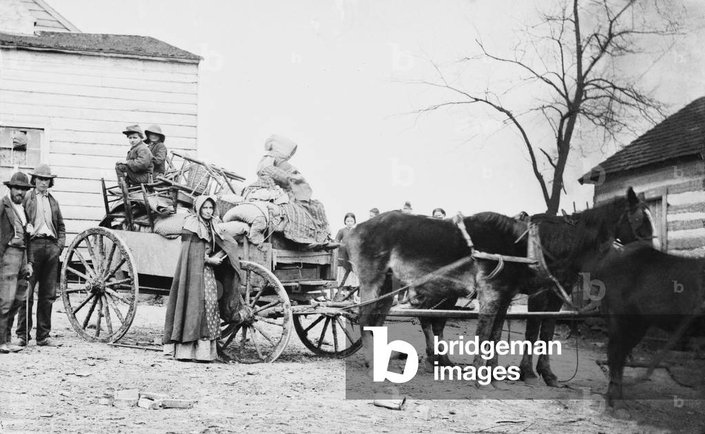 DEPARTURE FROM THE OLD HOMESTEAD, an 1862 photograph by George Barnard shows a American family on the move during the Civil War. The pipe smoking woman may be a descendant of early Scotch-Irish settlers who populated the Appalachians in the 18th century, and whose women smoked pipes into the 20th century