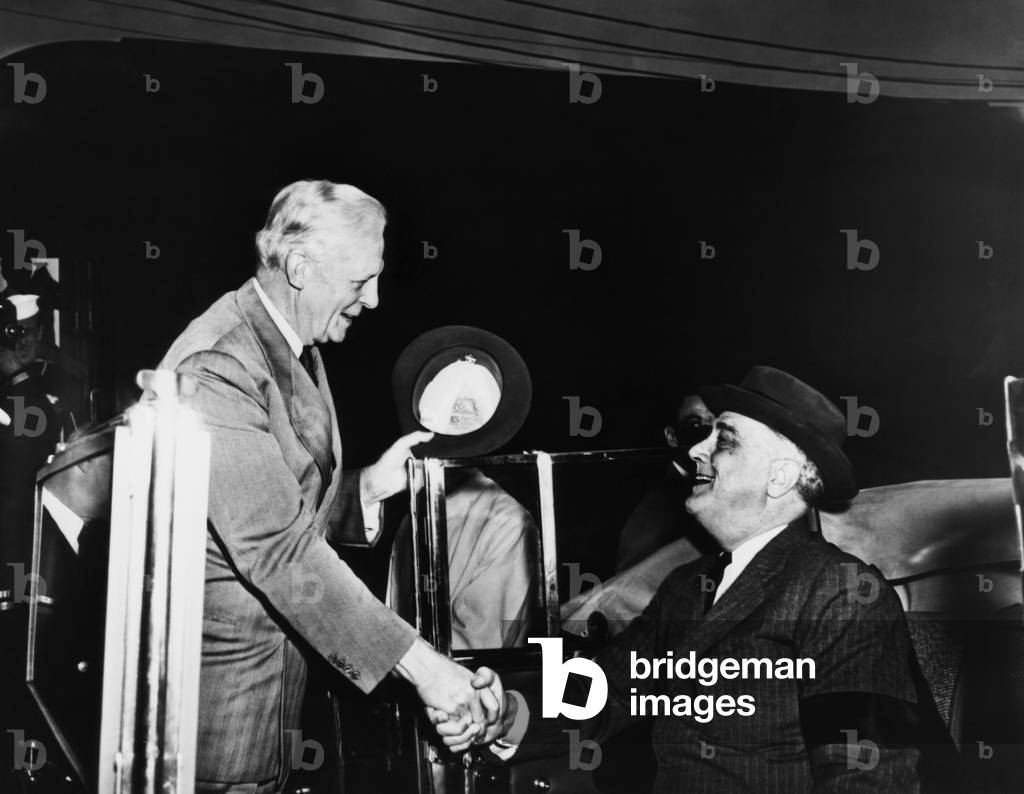 President Franklin D. Roosevelt (right), greets Governor Culbert L. Olson of California before an inspection tour of the Douglas Aircraft Corporation plant at Long Beach, California, November, 1942