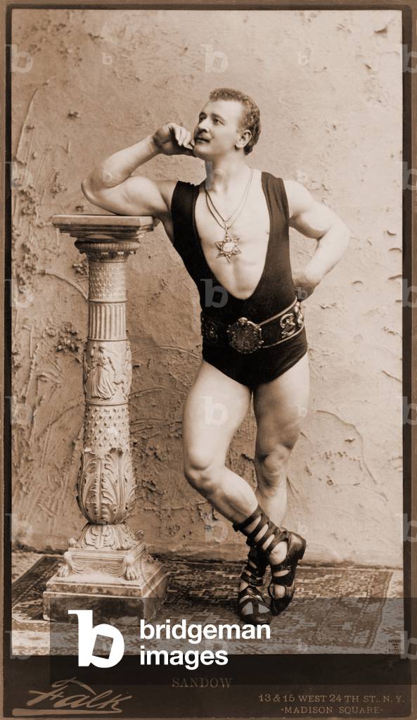 Eugen Sandow (1867-1925), German born strongman, wearing wrestling leotard, Roman sandals, and six pointed star pendant. 1894