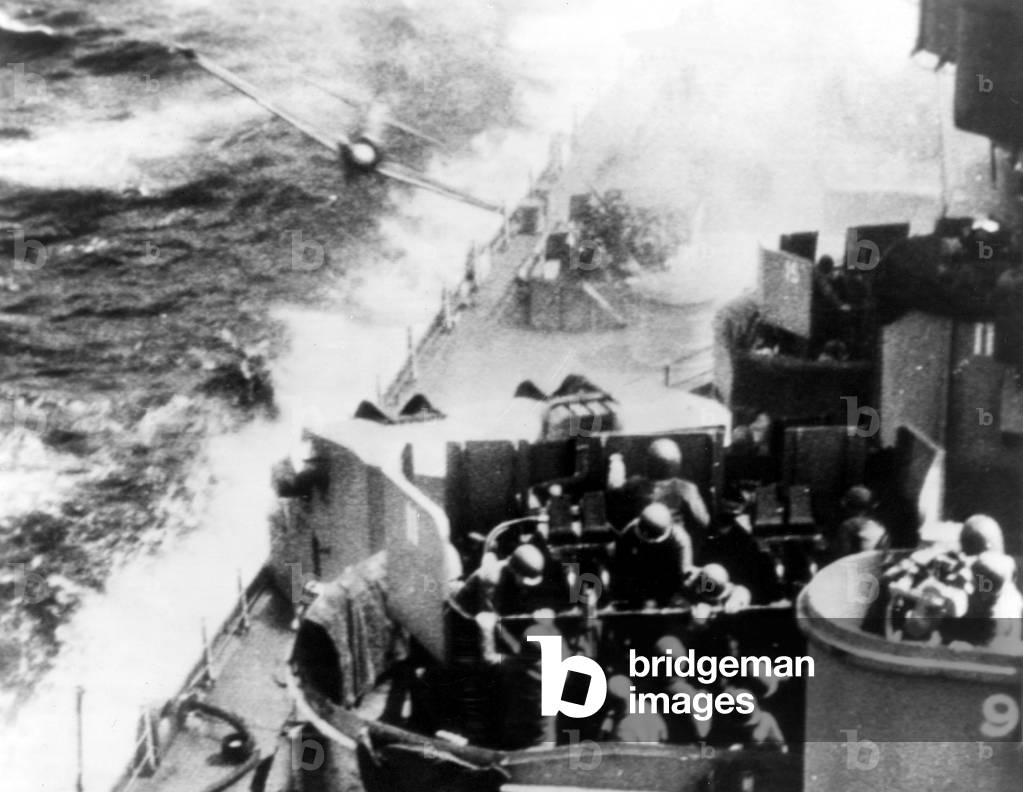 World War II: Suicide-bent, this pilot of a Japanese Zeke plane desperately tries to crash into the deck of U.S. Pacific Fleet warship. The cameraman catches the plane just before it ends its unsuccessful attack by crashing into the sea.