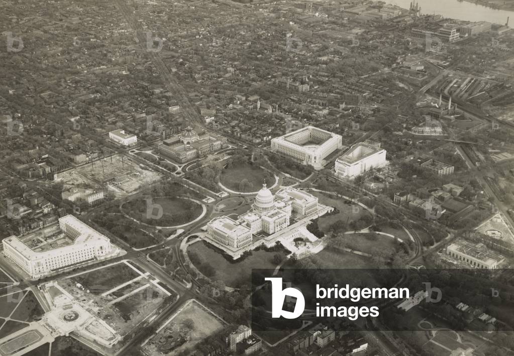 Aerial photo of Capitol Hill, May 1, 1932, with a view of the U.S. Capitol and vicinity. View to the northeast includes Library of Congress' Thomas Jefferson Building; House and Senate office buildings; and the construction site of the Supreme Court.