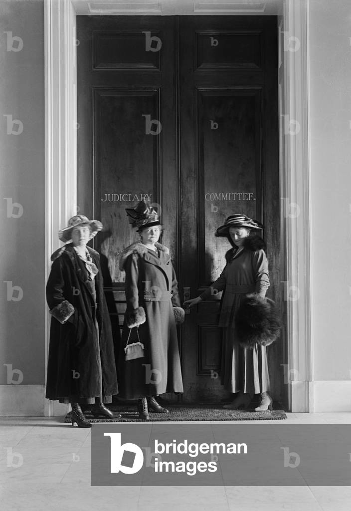 Women suffragists at the doors of the House Judiciary Committee in the House Office Building. 1916