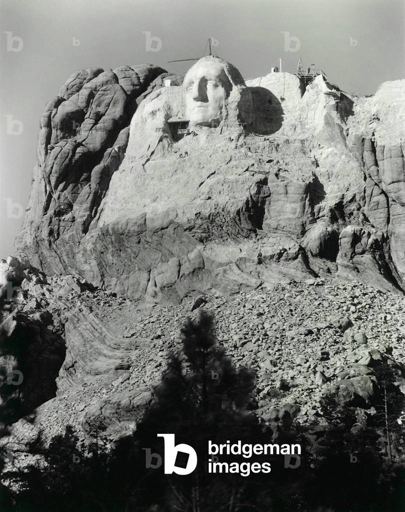 The first attempt at Thomas Jefferson on Mount Rushmore to the left of George Washington's head. It was blasted off due to poor rock quality and placed to the right of Washington, early 1930s