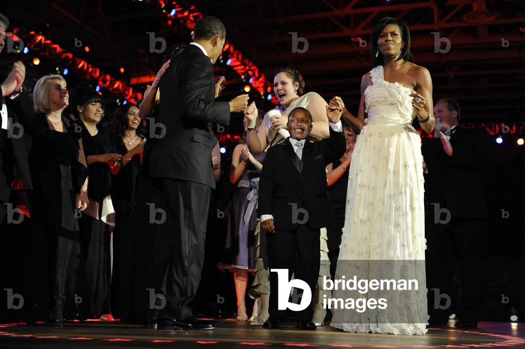 President and Michelle Obama dance with guests at the Neighborhood Ball. Michelle is wearing an ivory chiffon one shoulder dress by Jason Wu. Jan. 20 2009. Jan. 20 2009. (BSWH_2011_8_187)