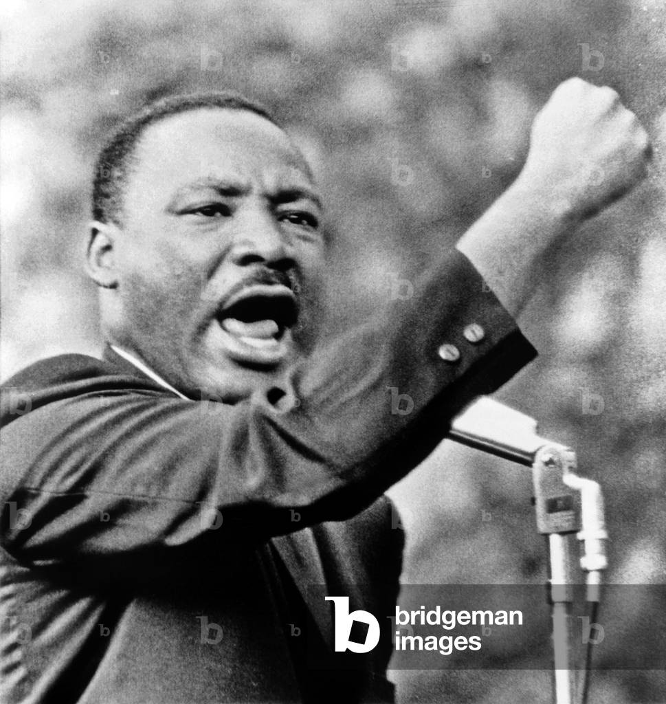 Martin Luther King: Martin Luther King, Jr., gesturing with right fist while delivering speech at Girard College, Philadelphia, on Aug. 3 1965 (b/w photo)