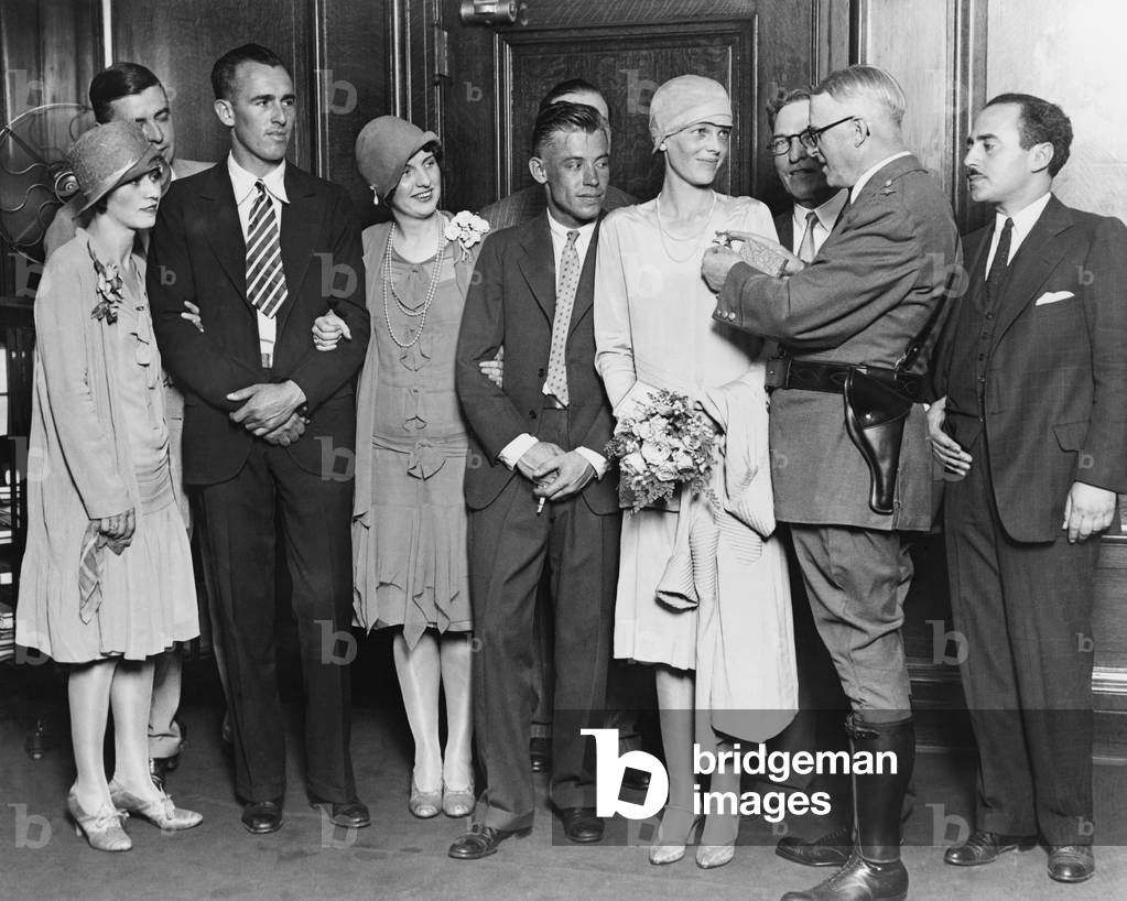 Chicago Chief of Police Michael Hughes pinning a star on Amelia Earhart on July 19, 1928. Left to right: Mrs. Stultz, Lou Gordon, Ann Bruce, Mr. Stultz, Amelia Earhart, Chief Hughes, and Acting Mayor William D. Saltiel