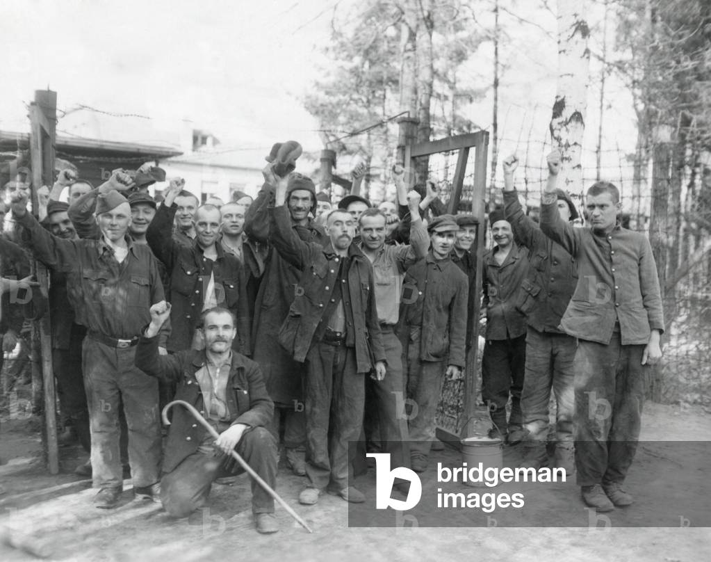 Allied POW cheer their liberty after being freed near Homburg, Germany, by 7th U.S. Army troops. Some of the Russians, Czechs, Poles, and French had been prisoners for three years. March 22, 1945. World War 2