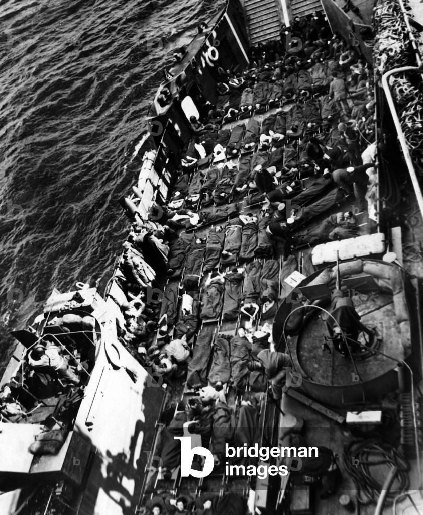 Wounded U.S. and British soldiers being taken away from the capture of Cherbourg, June 28, 1944