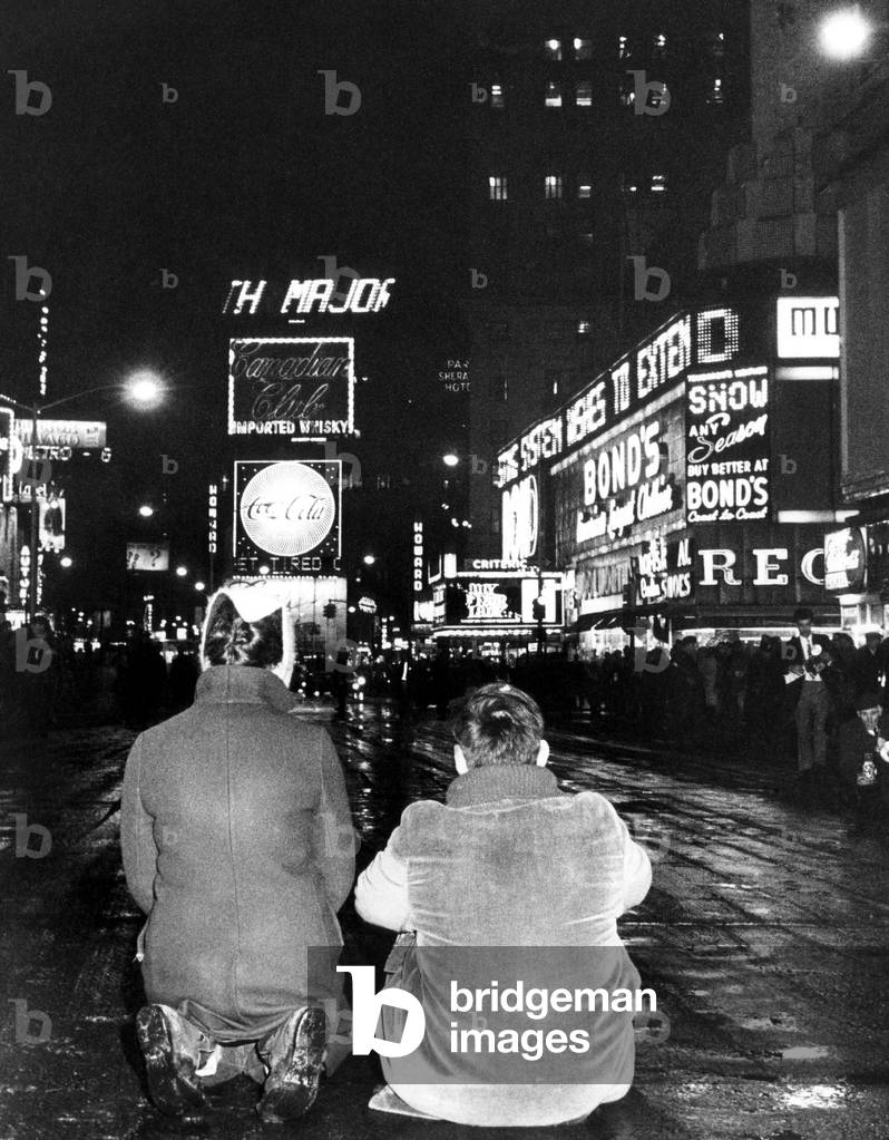 Times Square, with traffic halted by two demonstrators for peace in Vietnam. New York, New York. January 1, 1966.