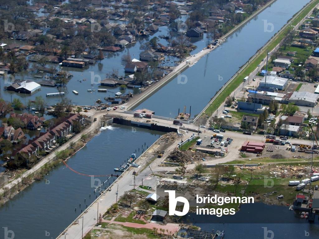 New Orleans after Hurricane Katrina showing a levee break under repair and flooding on one side with the other intact and dry. Sept. 2005