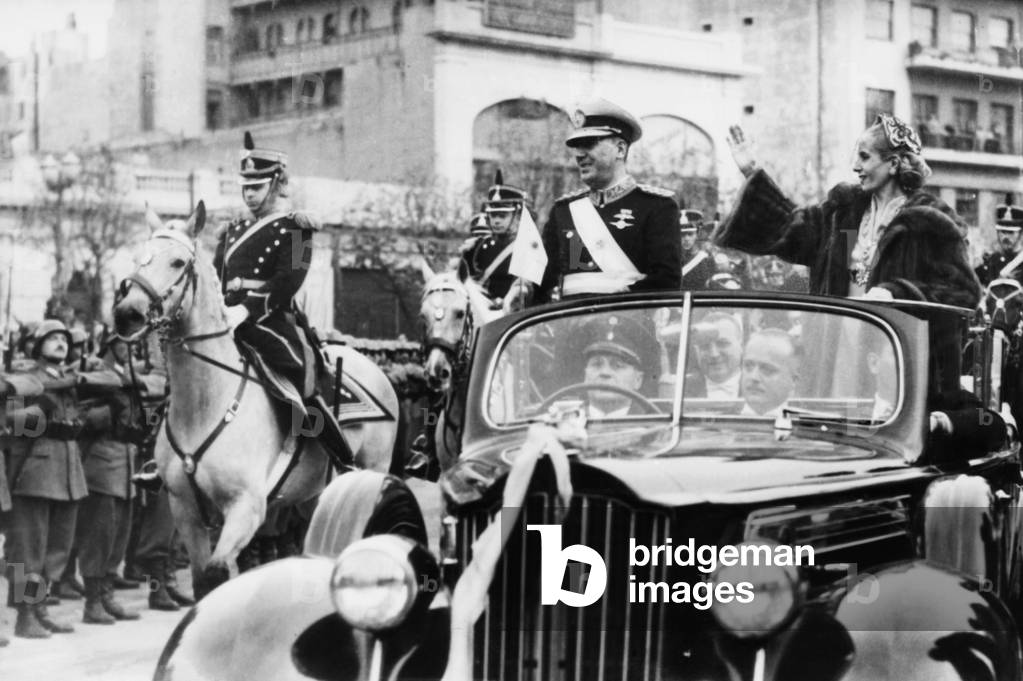 Eva Peron riding in an open car in President Juan Peron's second term inaugural parade. June 4, 1952. Eva, weakened by advanced cancer, was supported by a frame made of plaster and wire underneath her oversized fur coat. She died weeks later on July 26, 1952.