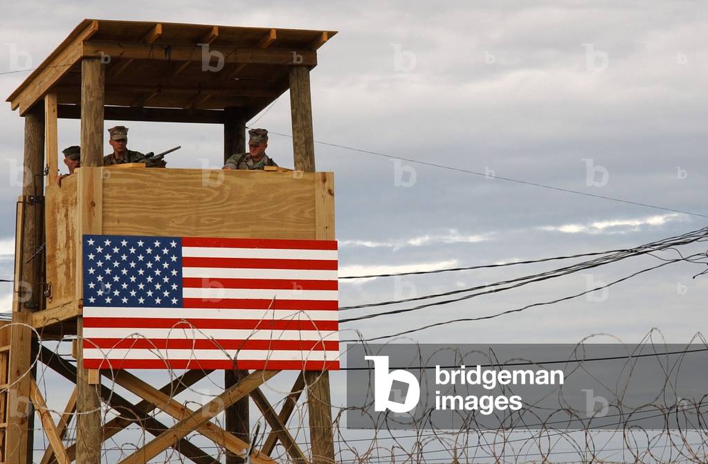 Watch tower security teams at Camp X-Ray man positions during a rehearsal for handling incoming detainees Jan. 10 2002. Camp X-Ray the holding facility for suspected Taliban and Al-Qaeda combatants to be held at Naval Base Guantanamo Bay Cuba., Photo by:Everett Collection