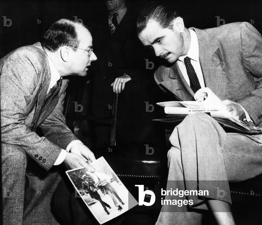Howard Hughes (right) confers with his counsel, Thomas A. Slack, at the Senate War Investigating sub-committee hearing, 1947