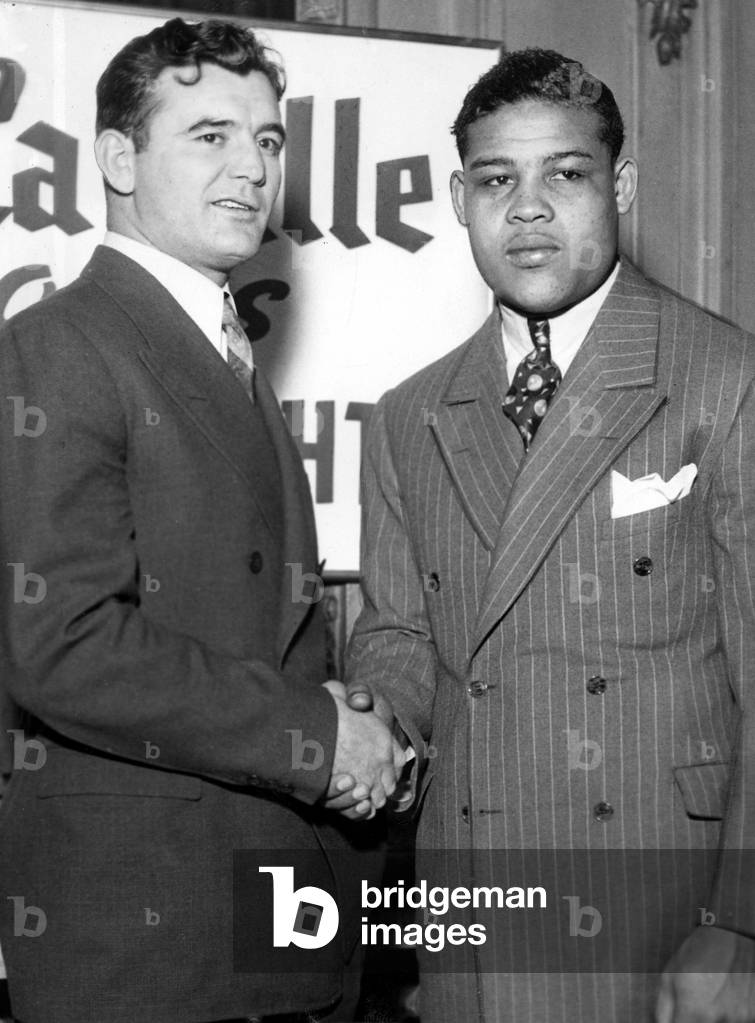 James Braddock and Joe Louis shake hands after signing contract for upcoming fight in Chicago, February 19, 1937