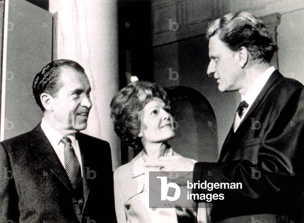 President Richard M. Nixon & First Lady Pat chat with Billy Graham after services in the White House, 3/15/70