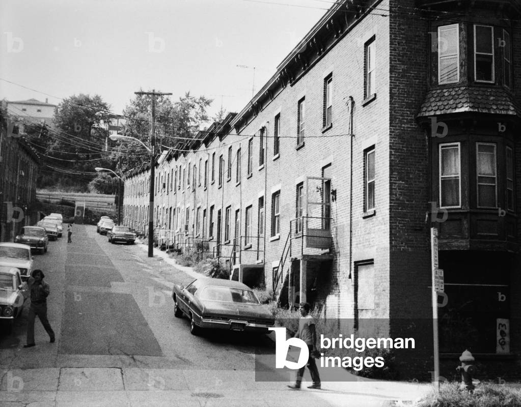 Yonkers, New York, c. 1980. Moquette Row Housing, built in the 1880s, with each individual house, approximately 17 - 20 feet wide. Row North and South, view west showing front elevation with original end structures. Westchester County, NY