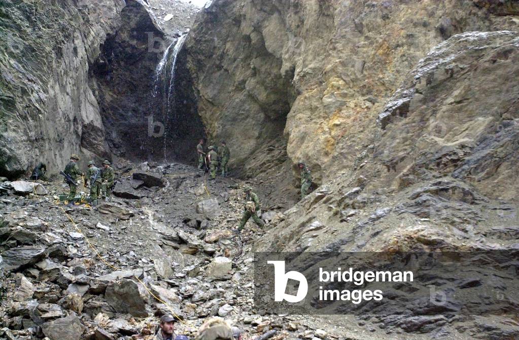 Canadian soldiers searching for Taliban and Al Qaeda forces prepare to blow an opening into the side of a mountain while looking for caves in the Tora Bora region in Afghanistan. May 5 2002., Photo by:Everett Collection