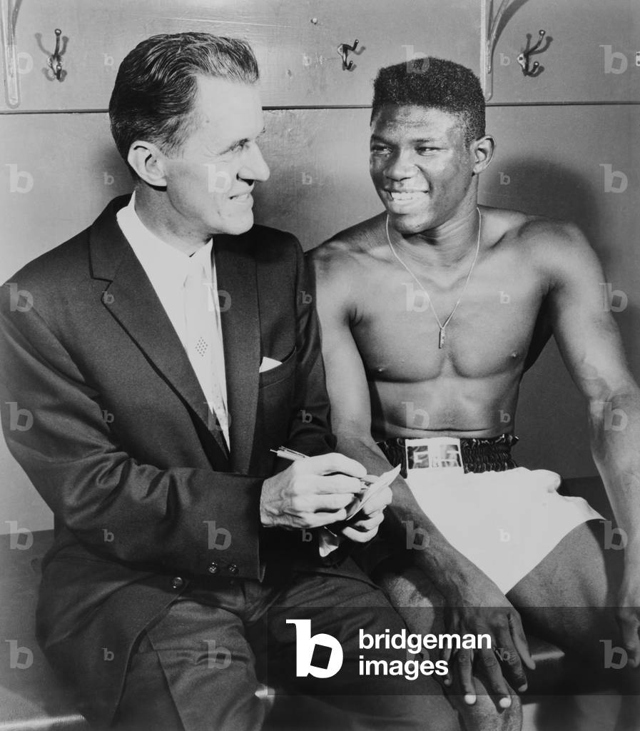 World welterweight champion Emile Griffith being interviewed by sportscaster, Dun Dunphy. 1961