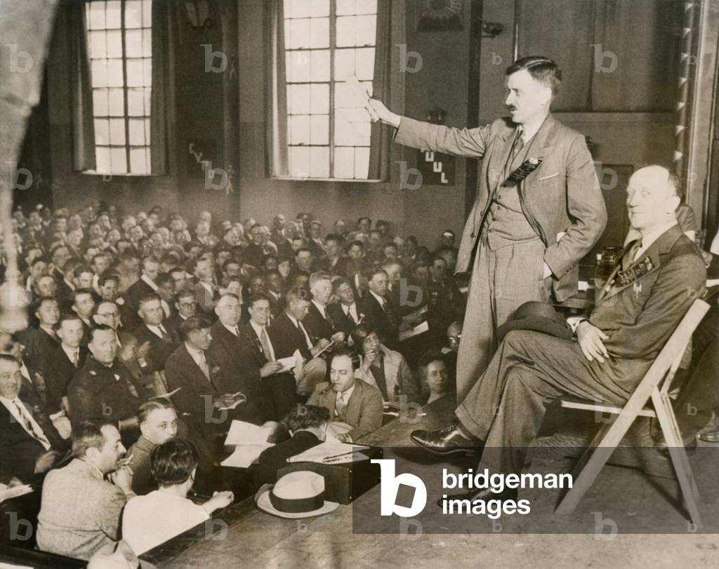 Earl Browder, making the keynote address at the Communist Party Convention, Chicago, May 29, 1932. Browder was National Secretary of the CPUSA and would be it's candidate for President in the 1932 National election. William Foster, seated beside him, ran as CPUSA vice presidential candidate