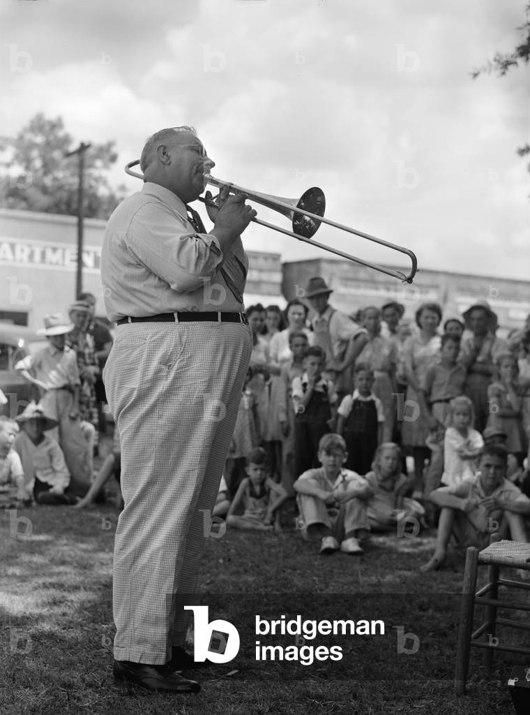 A Local band leader leads with 'An Old Southern Melody' and everybody cheered, home guard passes through Enterprise, Coffee County, Alabama, photograph by John Collier, August 1941
