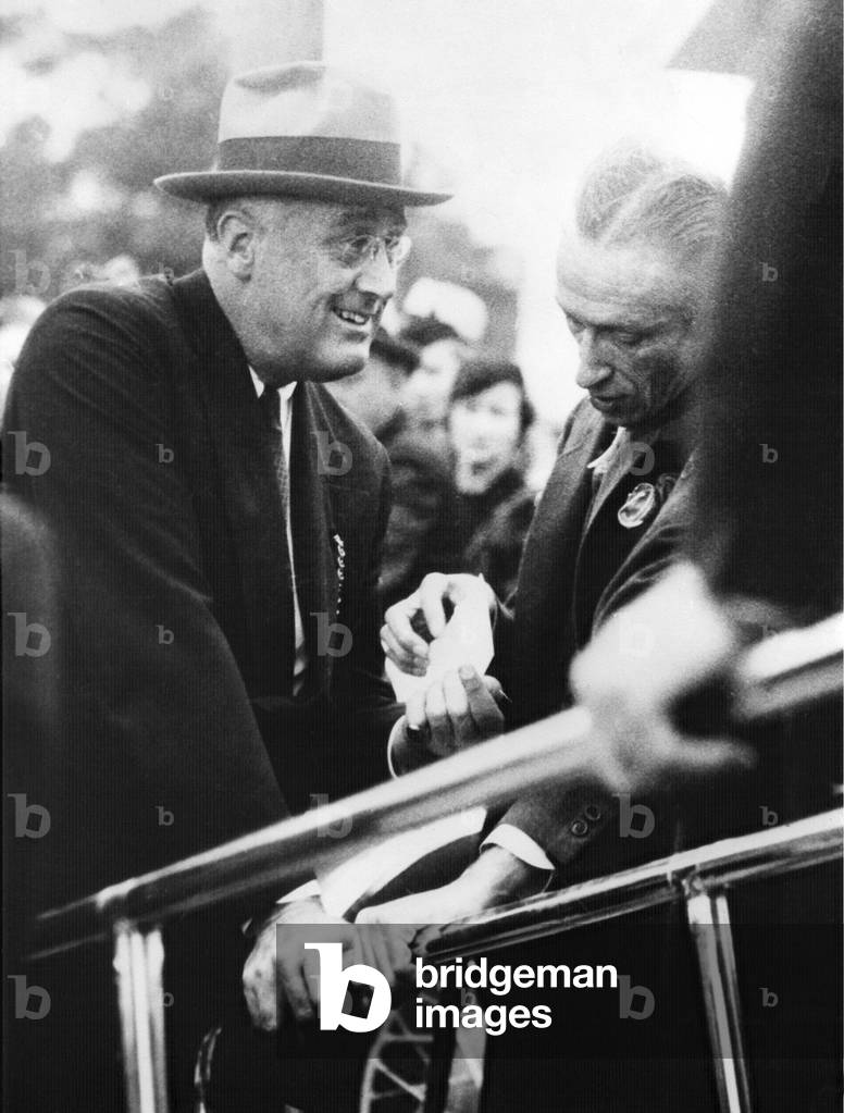 Franklin Roosevelt supporting himself on ramp handles. Warms Springs, 1936. He is assisted by Warm Springs Registrar, Fred Botts
