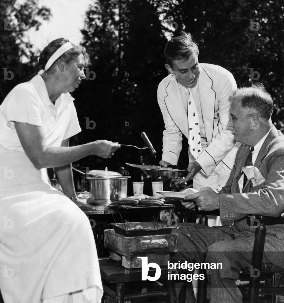 FDR Presdidency. First Lady Eleanor Roosevelt, Franklin Roosevelt Jr., and US President Franklin Delano Roosevelt, at family wiener roast, 1935