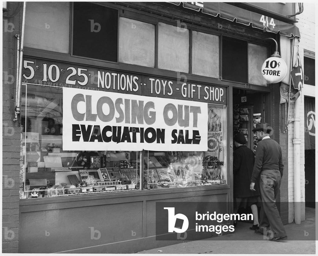 'Evacuation Sale' sign on a Japanese-American store in preparation for World War II relocation. Internees were given little notice and forced to abandon or sell their businesses at heavy losses