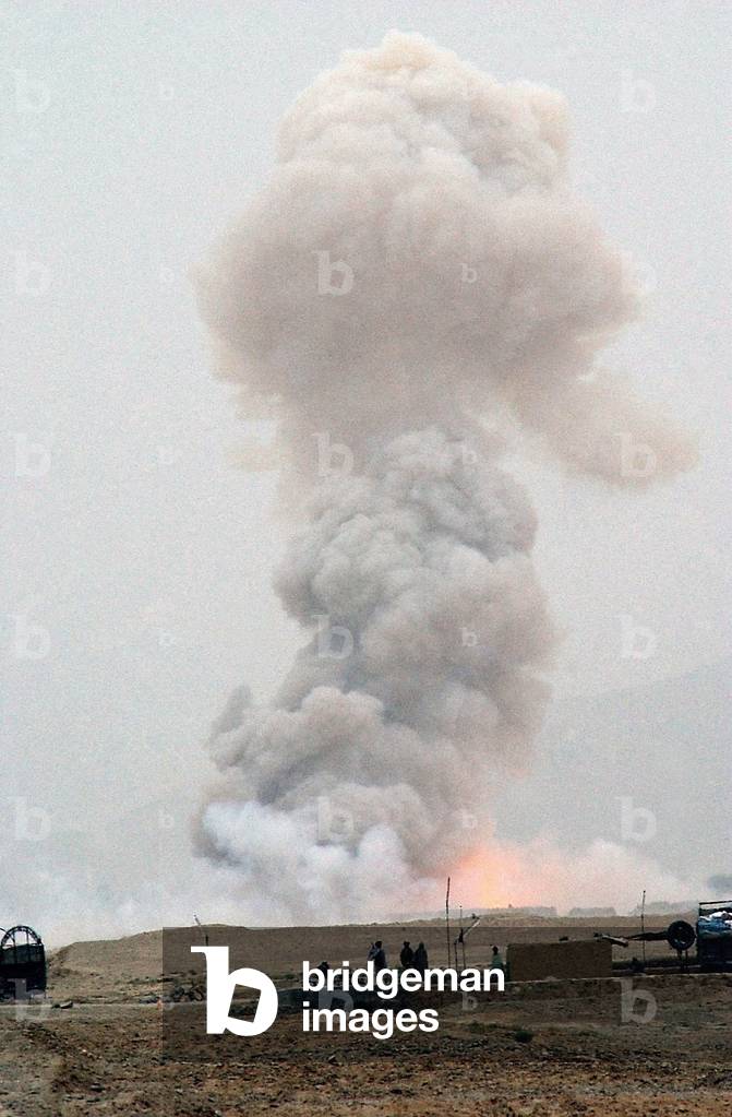 3000 pounds of bombs left behind by the Soviets go up in smoke. Confiscation and destruction of weapons was a major task of U.S. lead coalition forces., Photo by:Everett Collection
