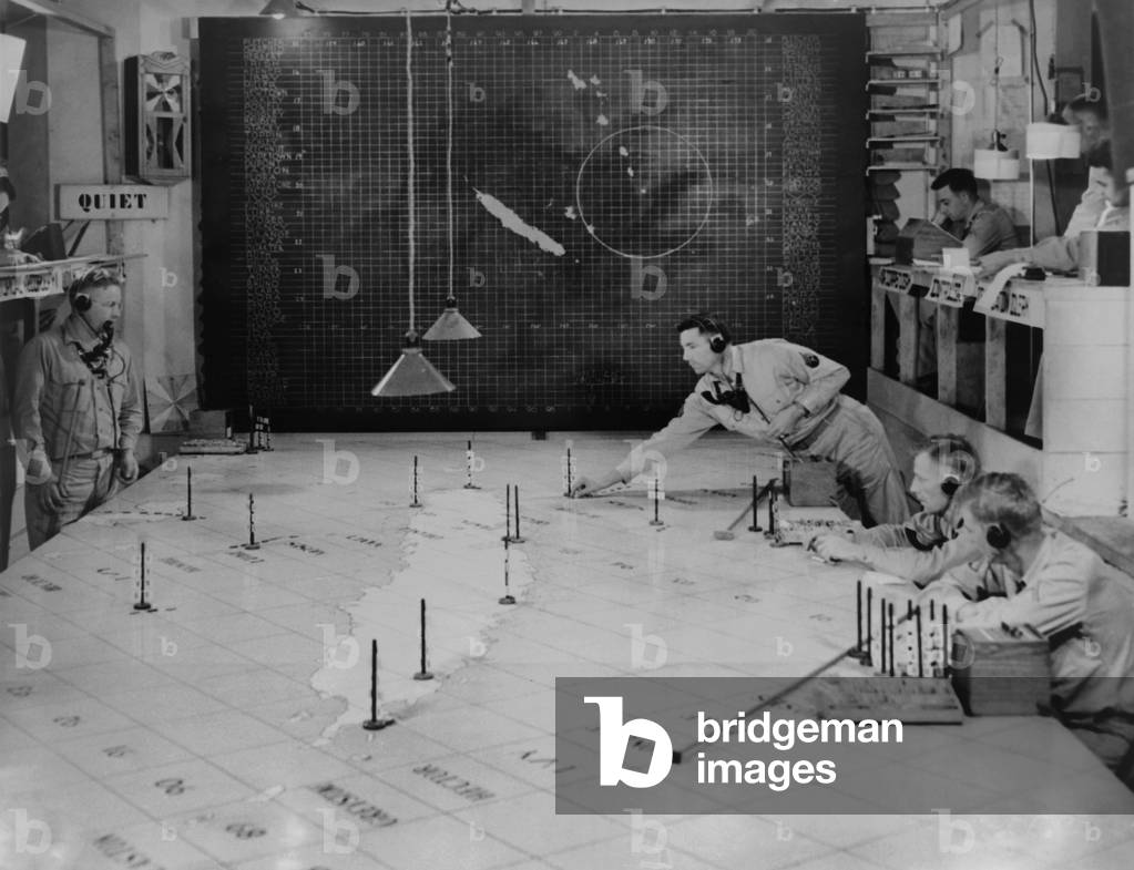 U.S. Army Signal Corps using radar plotting board. They track aircraft at 1st Island Command Headquarters, Noumea, New Caledonia. 1943. World War 2