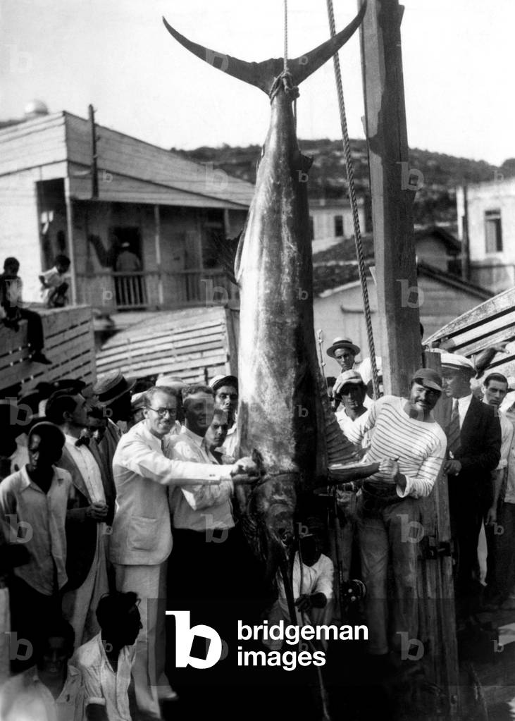 Ernest Hemingway (right) with a record breaking black-marlin caught on a recent fishing trip off the Cuban coast c. 1935.