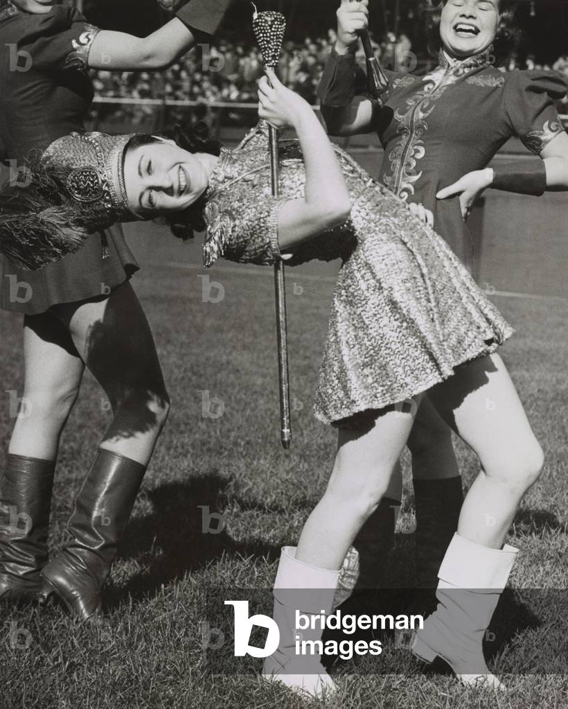 Lead majorette, doing a back bend while holding a baton. Nov. 22, 1939. New York City