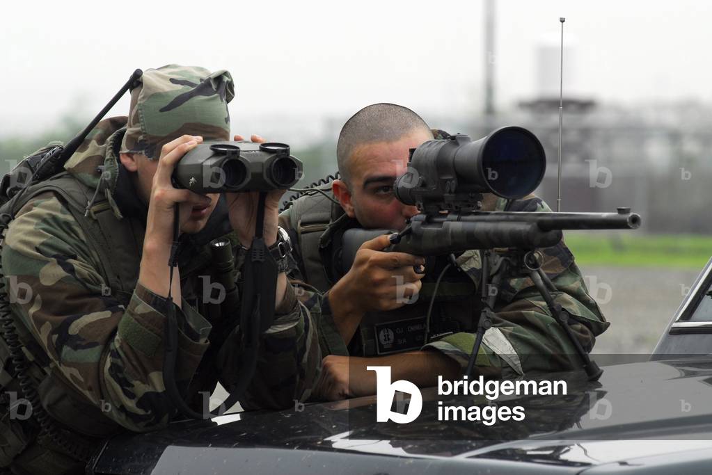 A sniper team search for opposing forces during an exercise at Osan Air Base South Korea July 23 2008