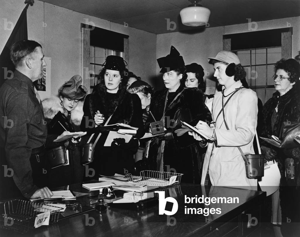 Women journalists taking notes in meeting with Brigadier General John Dahlquist, at Ft. Meade. Job opportunities opened to women in many fields during World War 2. 1942