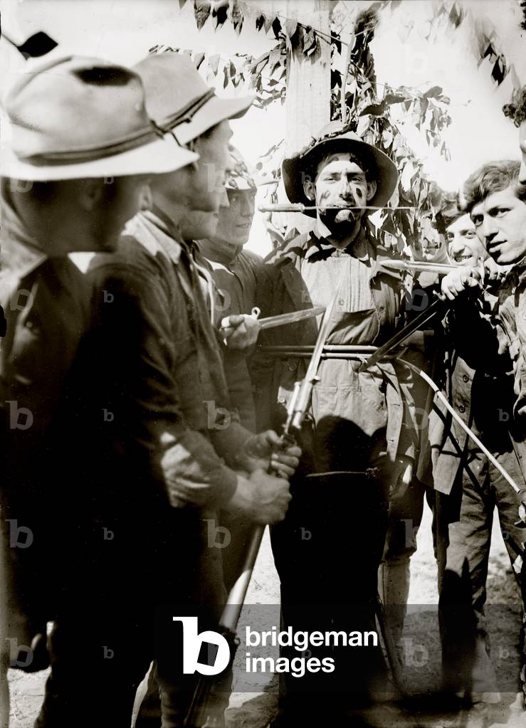 World War I, soldiers haze a new militiaman with knives at Fort Wadsworth military base, Staten Island New York, c.1908