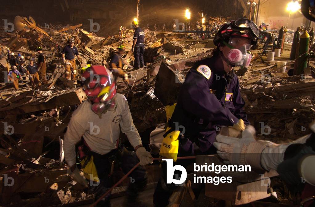 Workers lift rubble and search for survivors. Rescue operations continued into the night at the Ground Zero 7 days after the 9-11 attack on NYC, Sept. 19, 2001. World Trade Center, New York City, after September 11, 2001 terrorist attacks