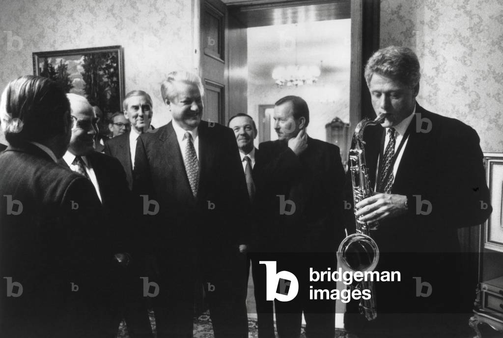 President Bill Clinton plays the saxophone presented to him by Russian President Boris Yeltsin. Yeltsin hosted a private dinner at Novoya Ogarova Dacha, Russia. Jan. 13, 1994