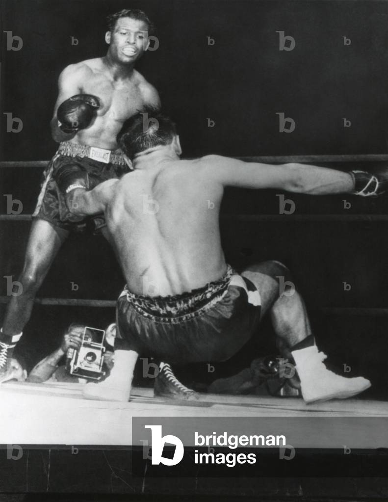 Robert Villemain, goes down from a punch by Sugar Ray Robinson in the 12th round. French middleweight got up and completed the fight. Robinson won by unanimous decision. June 5, 1950. Municipal Stadium, Philadelphia.